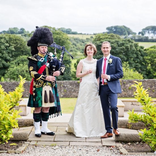 Wedding Piper Scotland in full regimental No1 uniform with Bride and Groom