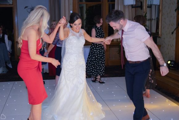 Bride dancing with guests at her wedding