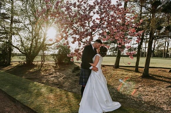 belvedere-scottish-ayrshire-wedding-photographer-supplier-venue-directory-bride-groom-kiss-outdoor-ceremony