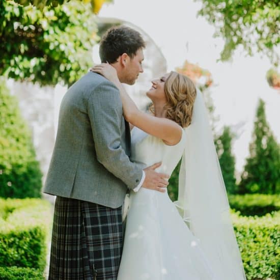 natalie-holt-central-scotland-wedding-photographer-supplier-venue-directory-bride-groom-outdoor-ceremony-kiss